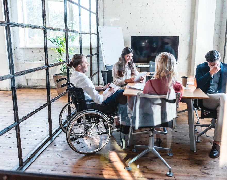 a group of employees laughing at a meeting